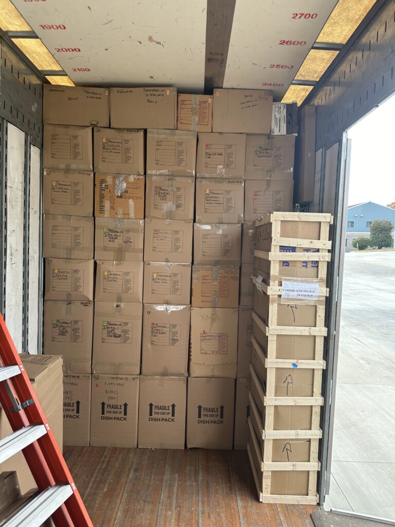 Custom-built crates and packed boxes inside a truck, ensuring the safe transport of fragile items with Pattons Movers' packing services in Winchester, VA.